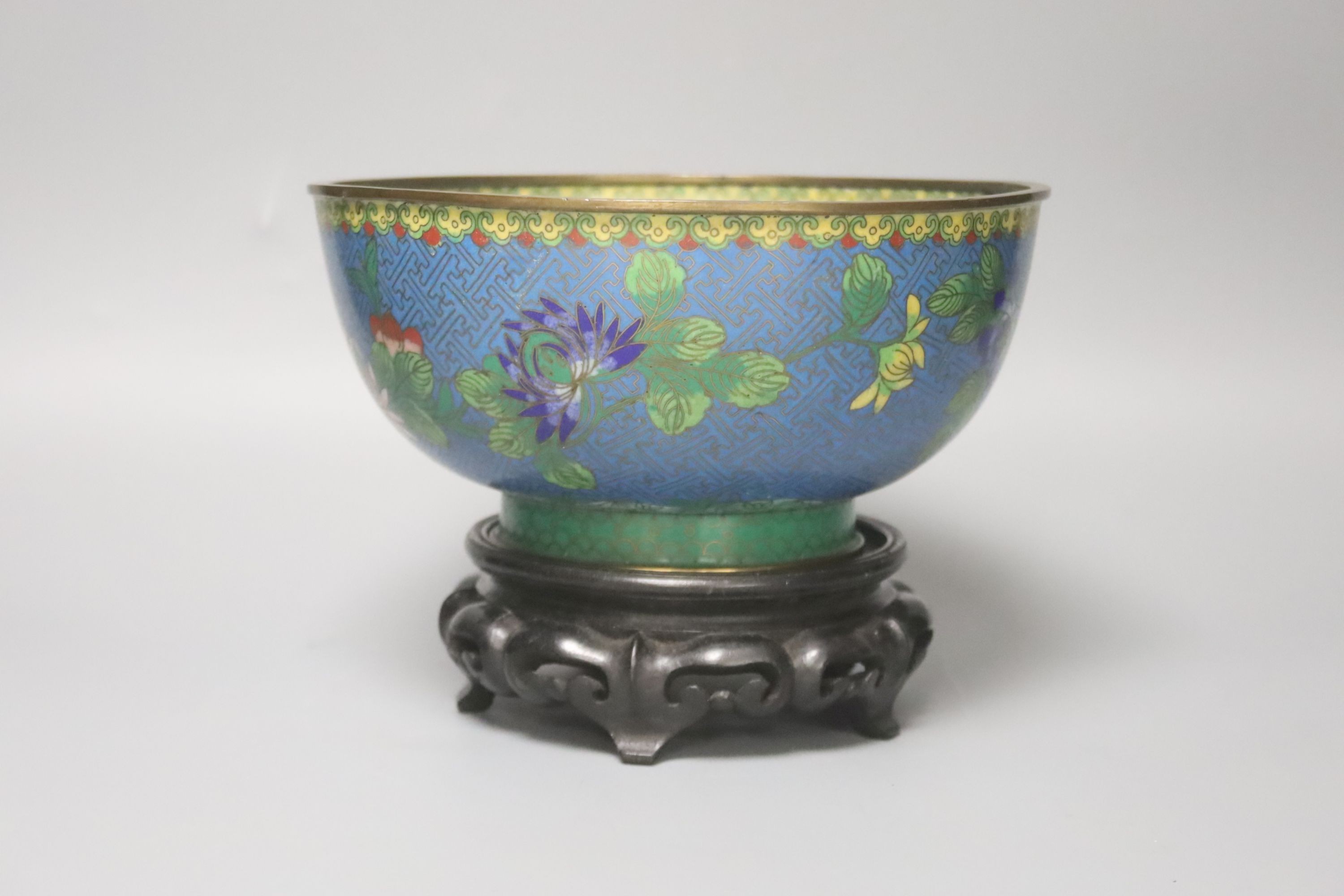 An early 20th century Chinese cloisonne enamel bowl, wood stand 20cm